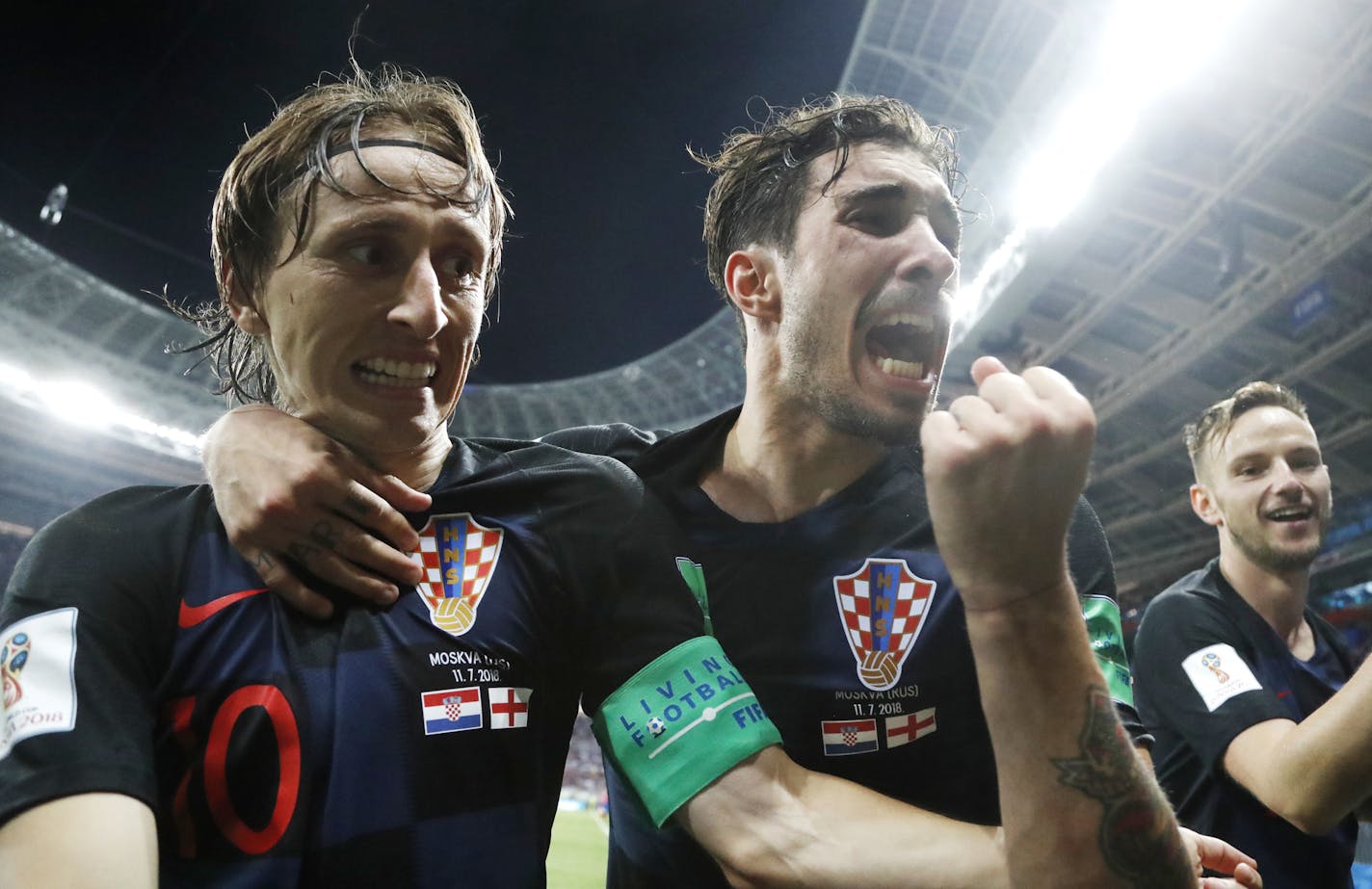 Croatia's Luka Modric, left, Sime Vrsaljko and Ivan Rakitic, right, celebrate after Croatia's Mario Mandzukic scored his side's second goal during the semifinal match between Croatia and England at the 2018 soccer World Cup in the Luzhniki Stadium in Moscow, Russia, Wednesday, July 11, 2018. (AP Photo/Frank Augstein)