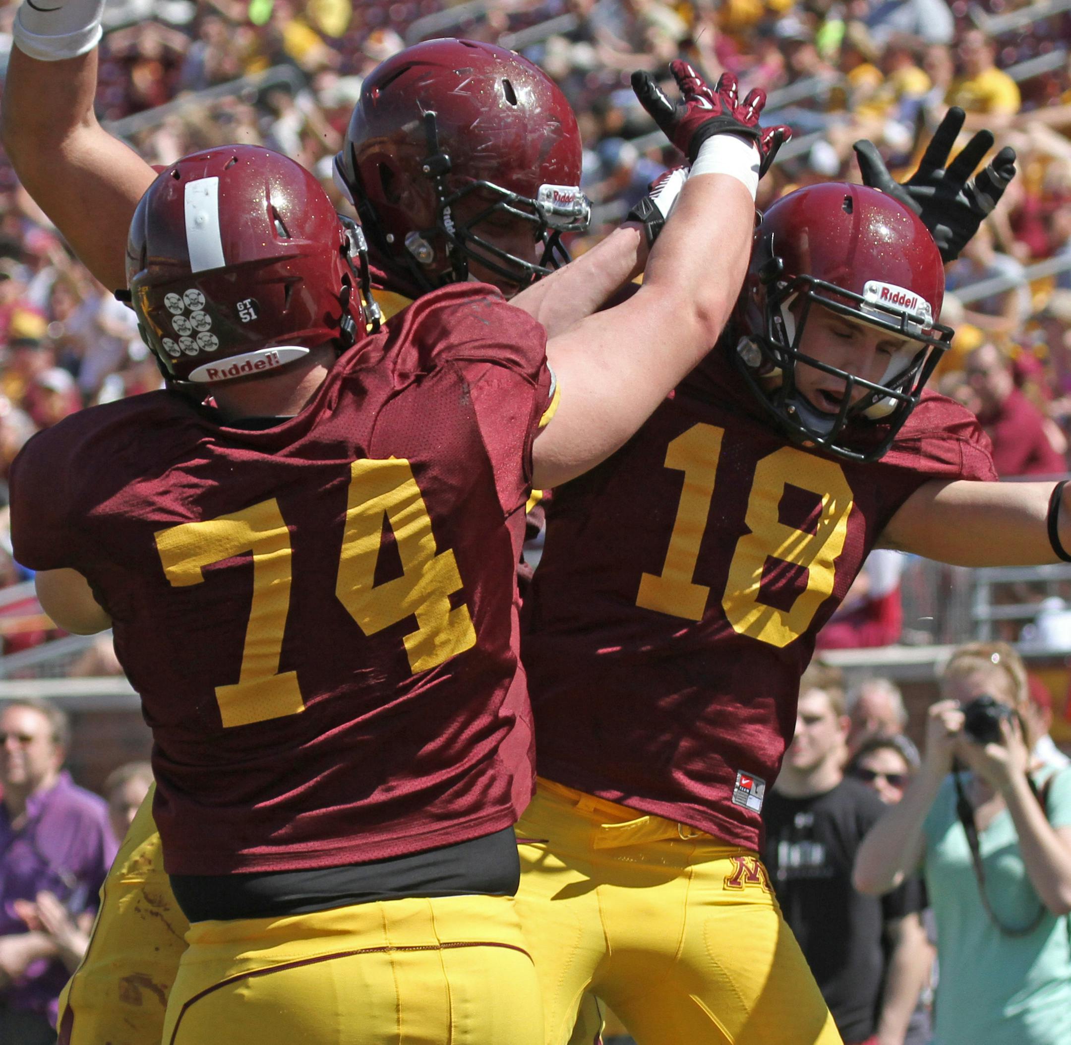 (left to right) Gophers Maroon team Marek Lenkiewicz, Joe Bjorklund and Derrick Engel celebrated after Engel scored a 2nd half touchdown during the spring game at TCF Stadium on 4/27/13.] Bruce Bisping/Star Tribune bbisping@startribune.com Marek Lenkiewicz, Joe Bjorklund, Derrick Engel/roster.