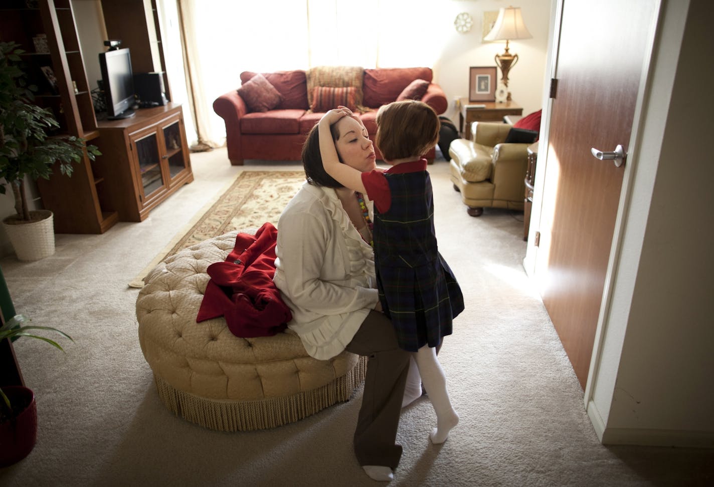 Single mom Kate-Madonna Hindes hugged her daughter, Ava, at their Chaska home before leaving to start her new job.