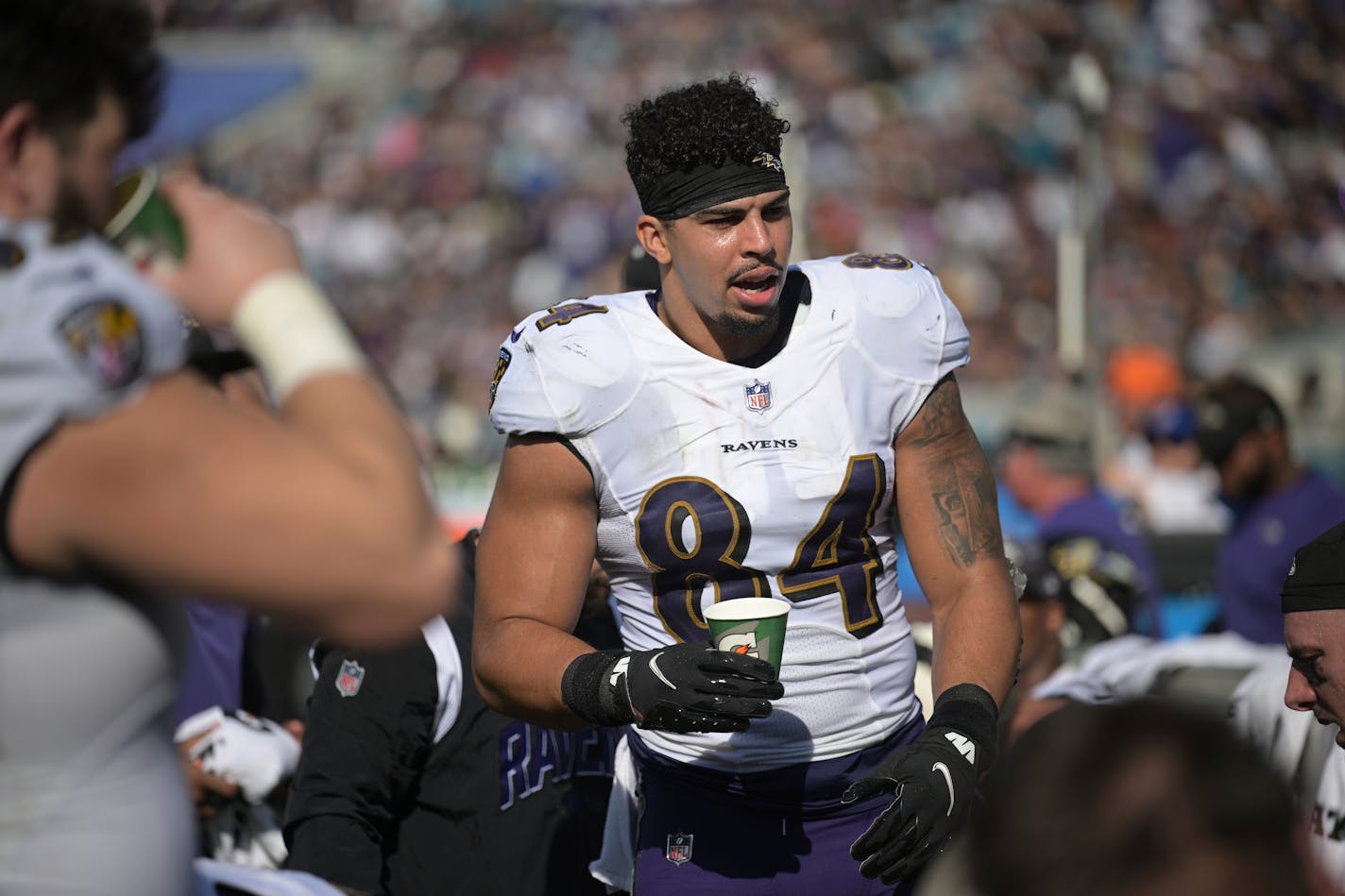 Baltimore Ravens tight end Josh Oliver (84) talks with teammates on the sideline during the first half of an NFL football game against the Jacksonville Jaguars, Sunday, Nov. 27, 2022, in Jacksonville, Fla. (AP Photo/Phelan M. Ebenhack) ORG XMIT: NYOTK