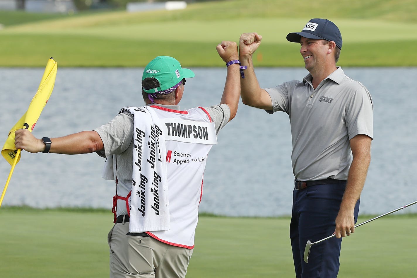 BLAINE, MINNESOTA - JULY 26: Michael Thompson of the United States celebrates with his caddie, Damian Lopez, on the 18th green after winning the 3M Open on July 26, 2020 at TPC Twin Cities in Blaine, Minnesota. (Photo by Matthew Stockman/Getty Images)