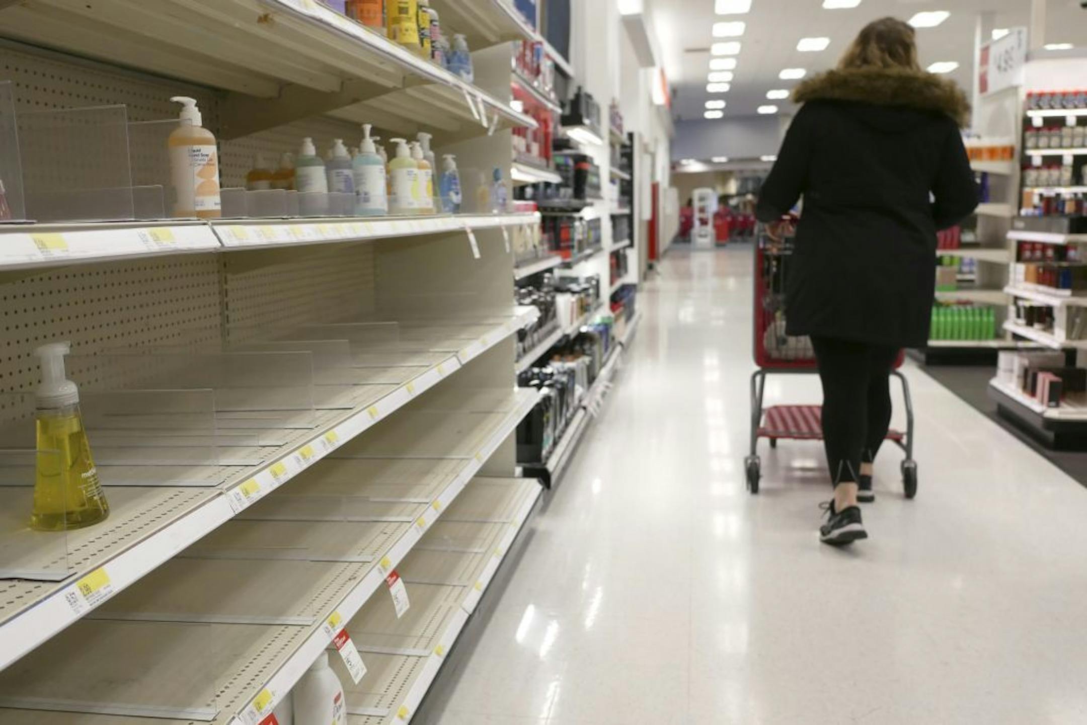 Shelves that held hand sanitizer and hand soap are mostly empty at a Target in Jersey City, N.J., Tuesday, March 3, 2020. Fear of the coronavirus has led people to stock up on hand sanitizer, leaving store shelves empty and online retailers with sky-high prices set by those trying to profit on the rush.