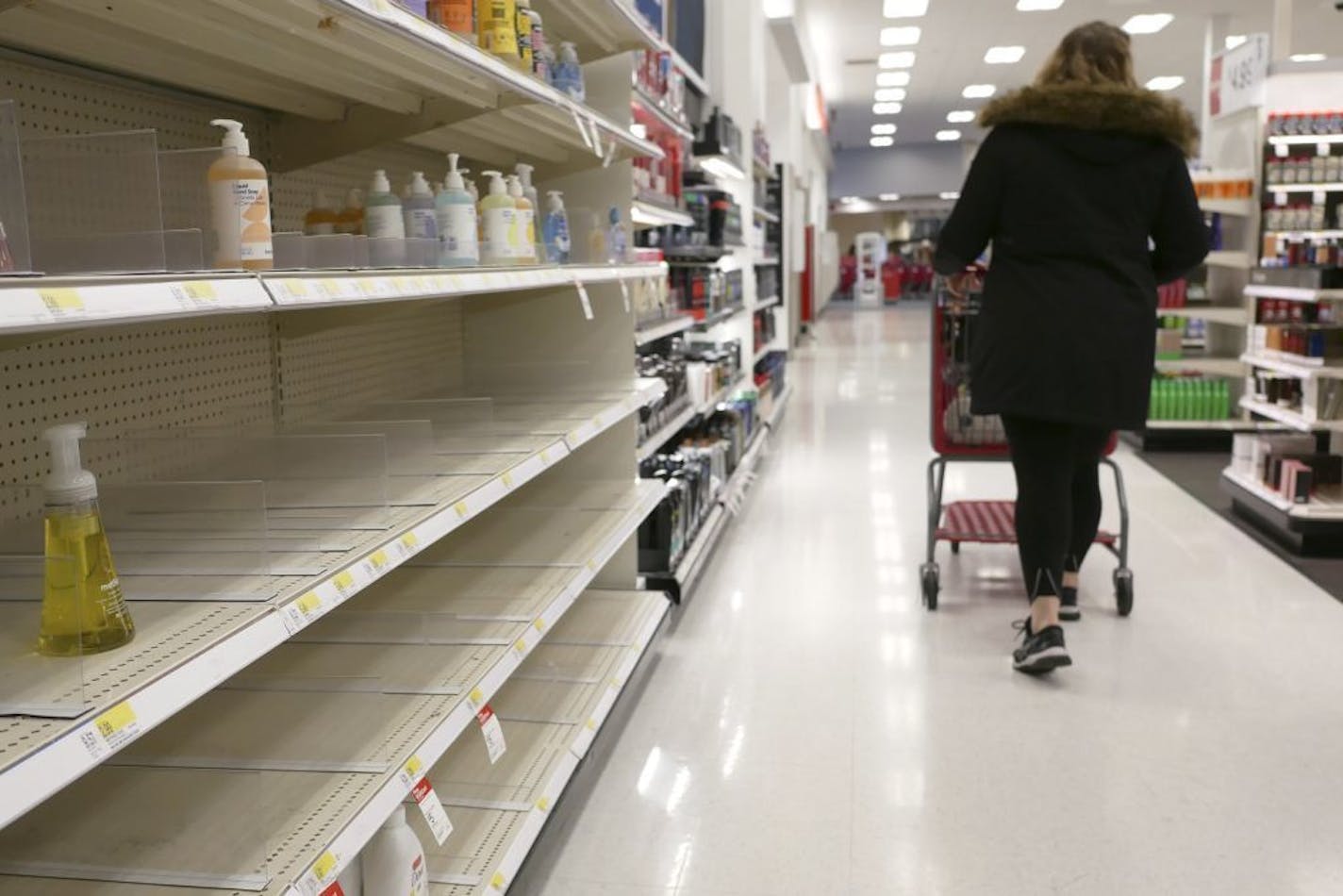 Shelves that held hand sanitizer and hand soap are mostly empty at a Target in Jersey City, N.J., Tuesday, March 3, 2020. Fear of the coronavirus has led people to stock up on hand sanitizer, leaving store shelves empty and online retailers with sky-high prices set by those trying to profit on the rush.