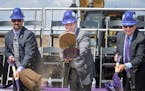 NFL Commissioner Roger Goodell, center, threw a shovelful of sand during the ceremony along with City of Eagan Mayor Mike Maguire, left and Lenny Wilf