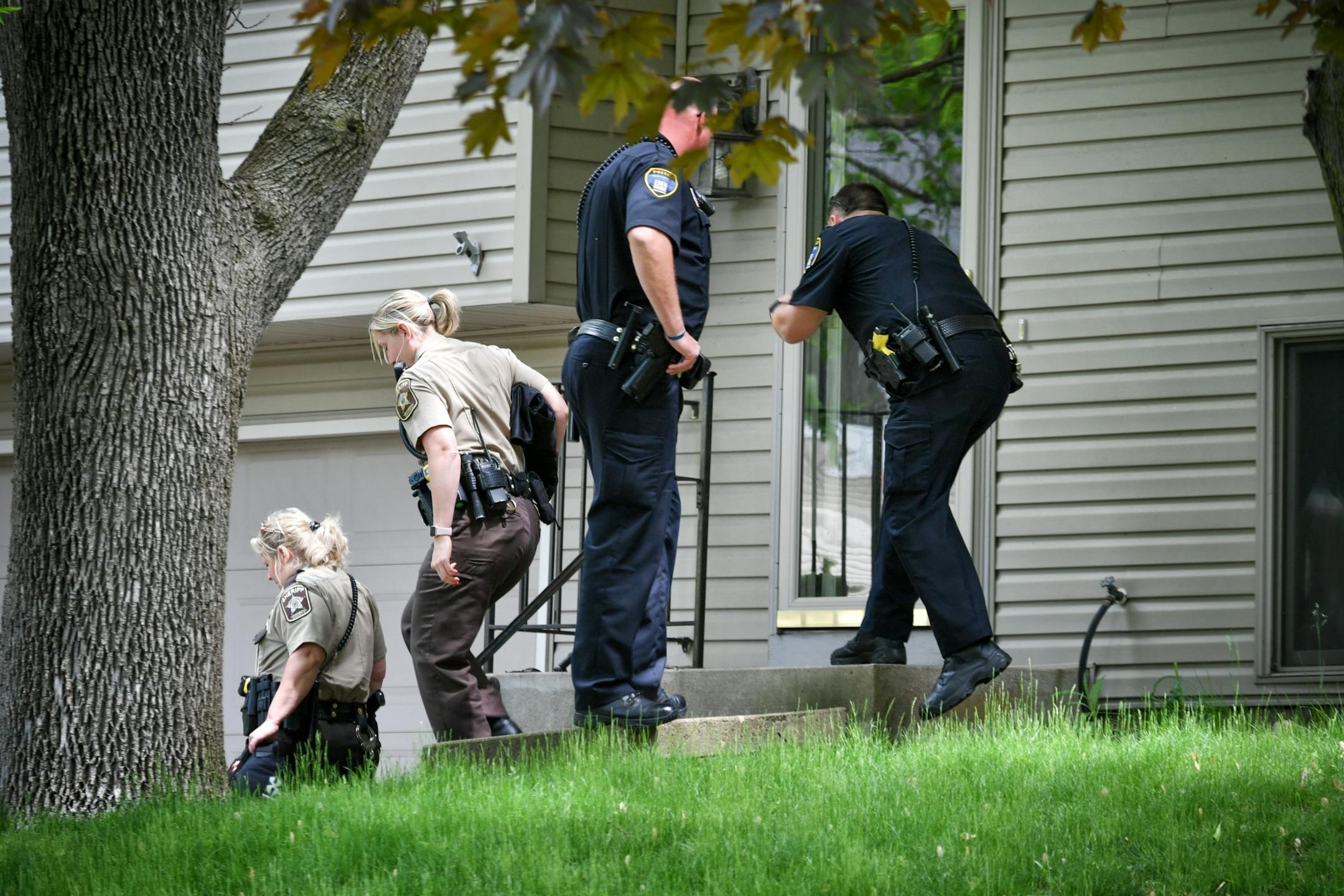 Eden Prairie Police and Hennepin County Sheriff's investigators talked with neighbors down the street from a home where two adults were found dead Thursday morning.