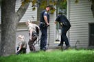 Eden Prairie Police and Hennepin County Sheriff's investigators talked with neighbors down the street from a home where two adults were found dead Thu