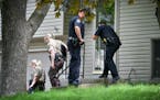 Eden Prairie Police and Hennepin County Sheriff's investigators talked with neighbors down the street from a home where two adults were found dead Thu