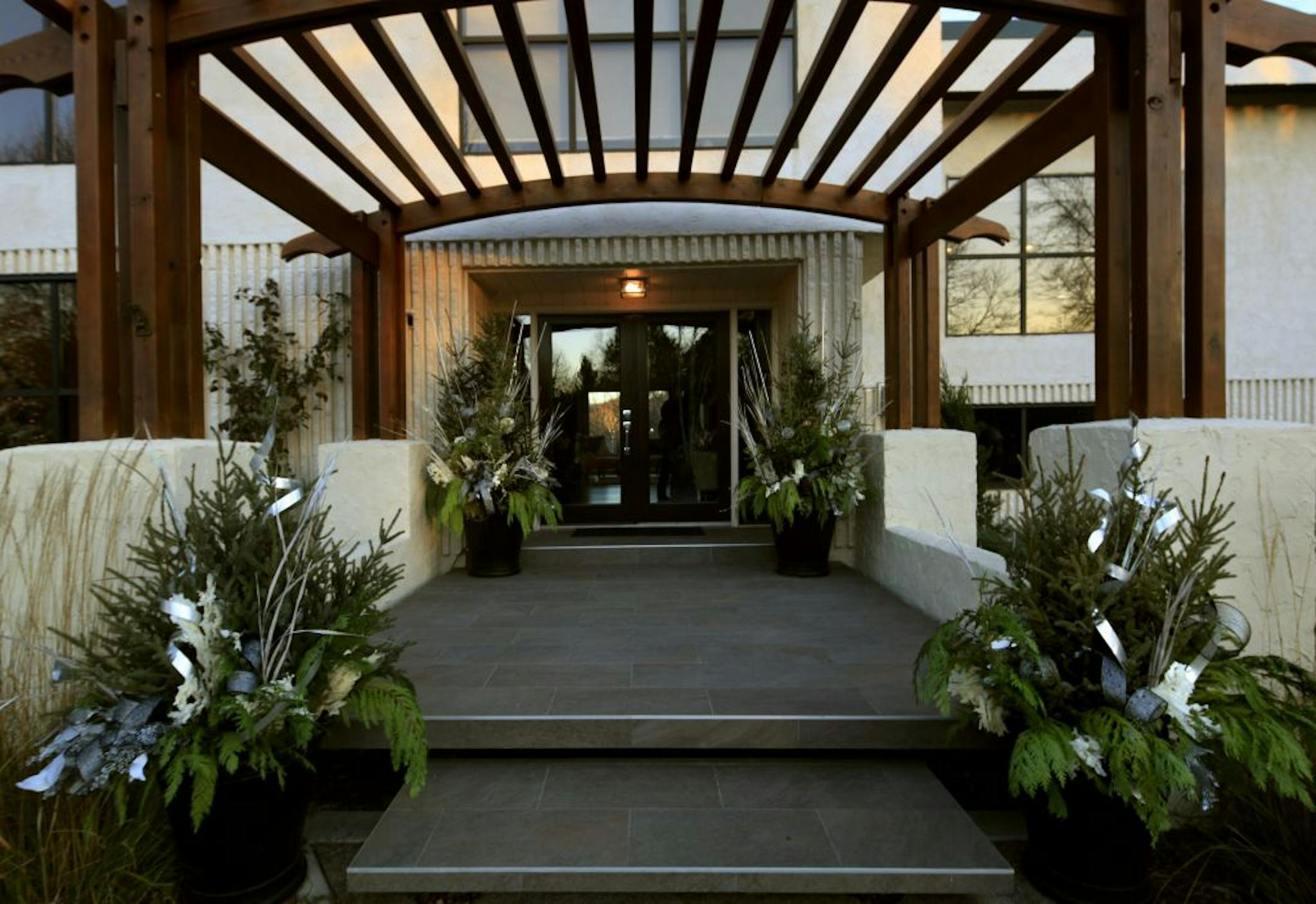Britta Wilson of Linder's designed the winter-themed urns on the front steps of a modern stucco home in North Oaks.