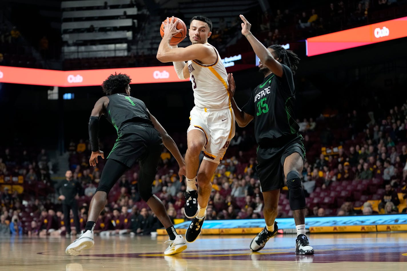 Minnesota forward Dawson Garcia works toward the basket as USC Upstate guard Nick Alvesl, left, and forward Ahmir Langlais, right, defend during the first half of an NCAA college basketball game, Saturday, Nov. 18, 2023, in Minneapolis. (AP Photo/Abbie Parr)