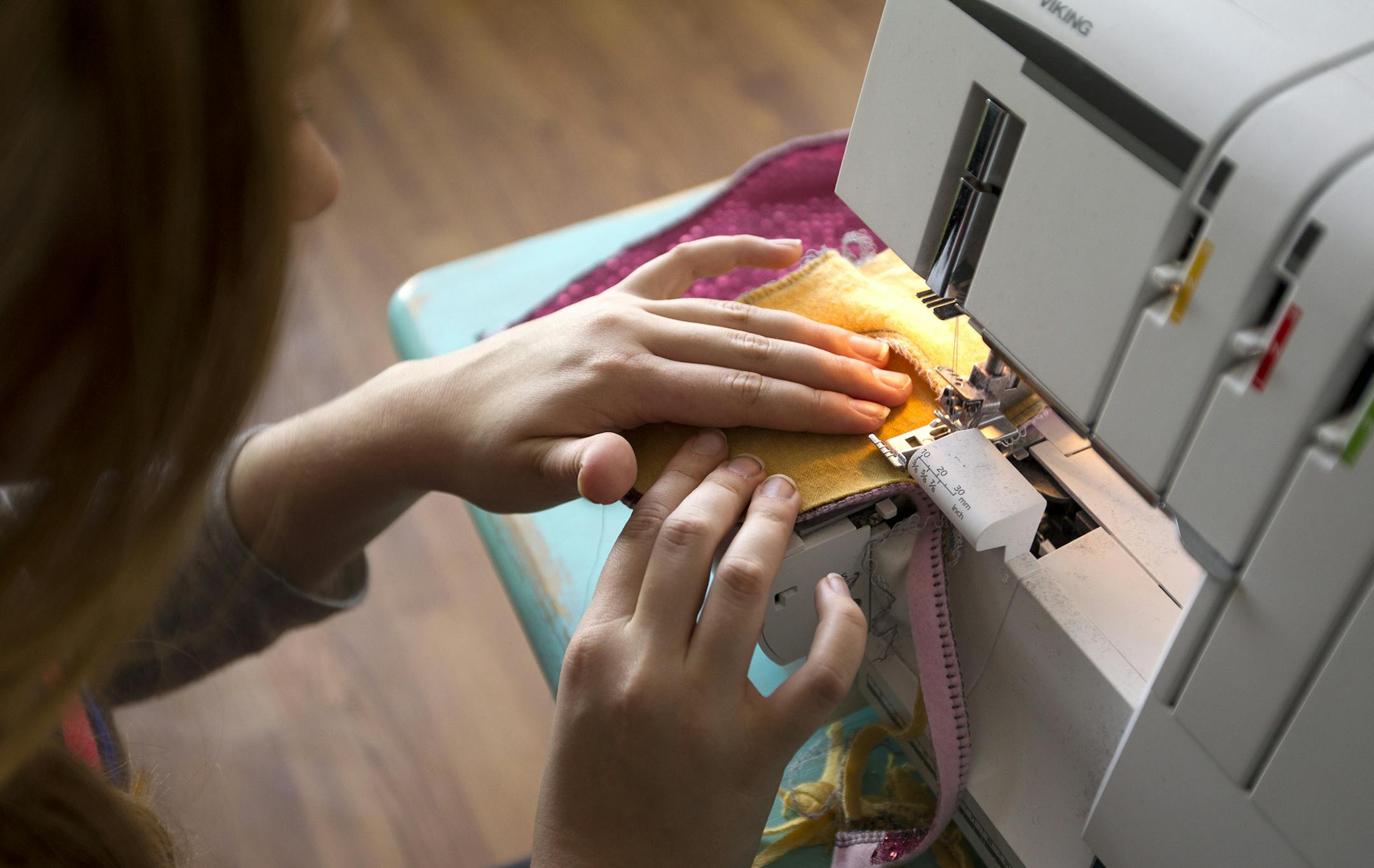 Sarah Vandelist sews mittens in her St. Paul studio December 23, 2013. (Courtney Perry/Special to the Star Tribune) ] A Macalester student and Lakeville North graduate, Vandelist started a business while in high school creating mittens from old sweaters. Years later, she has her own studio and a thriving business called Swag Mittens.
