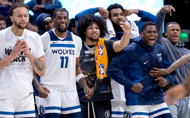 Players on the Minnesota Timberwolves cheer on teammates late in the fourth quarter on Monday.