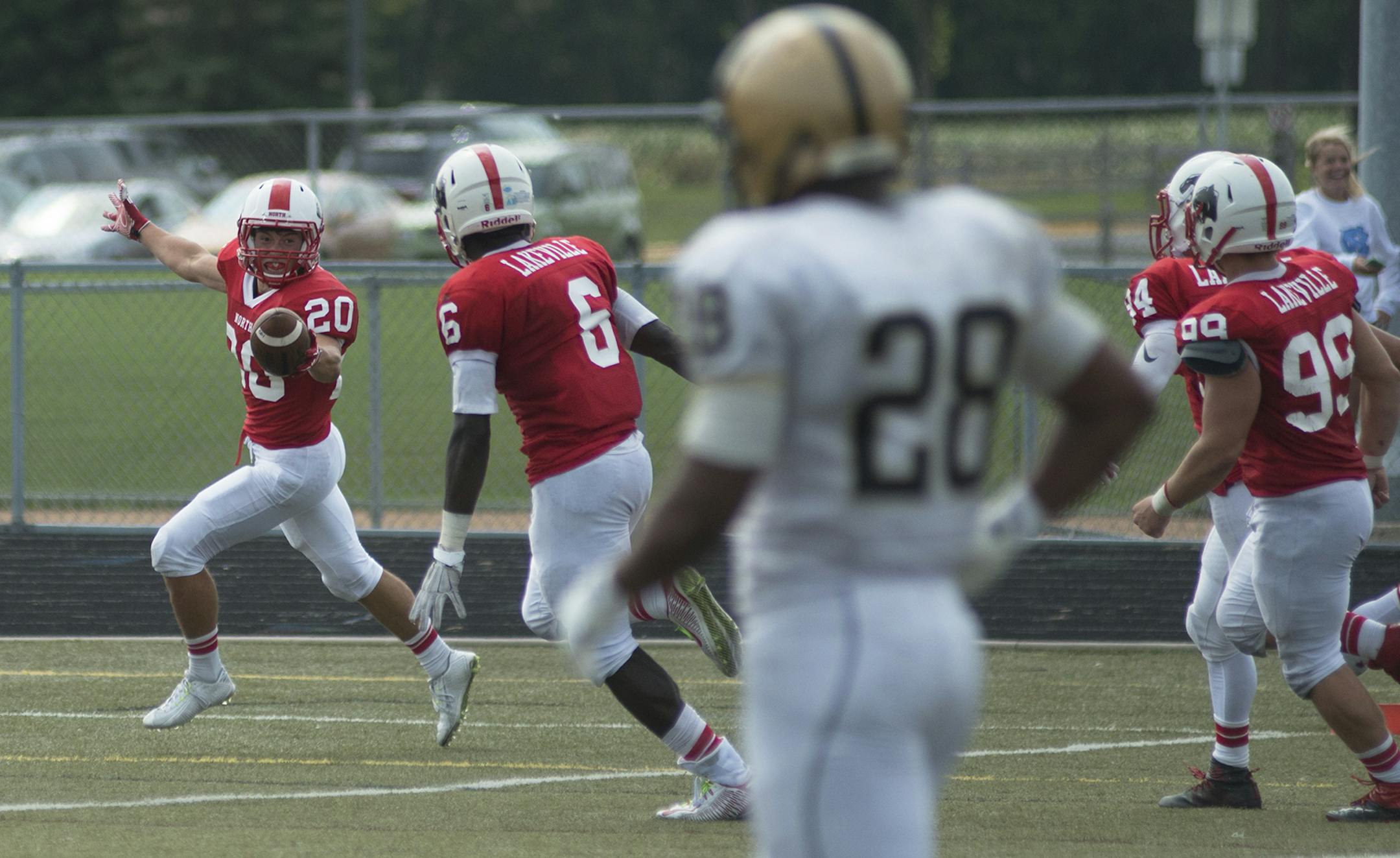 Lakeville North's Jadon Hatt returns an interception for a touchdown, Saturday, August 22, to put Lakeville North up 20-7 over East Ridge High School in the fourth quarter. (Matthew Hintz, 082215, Lakeville)