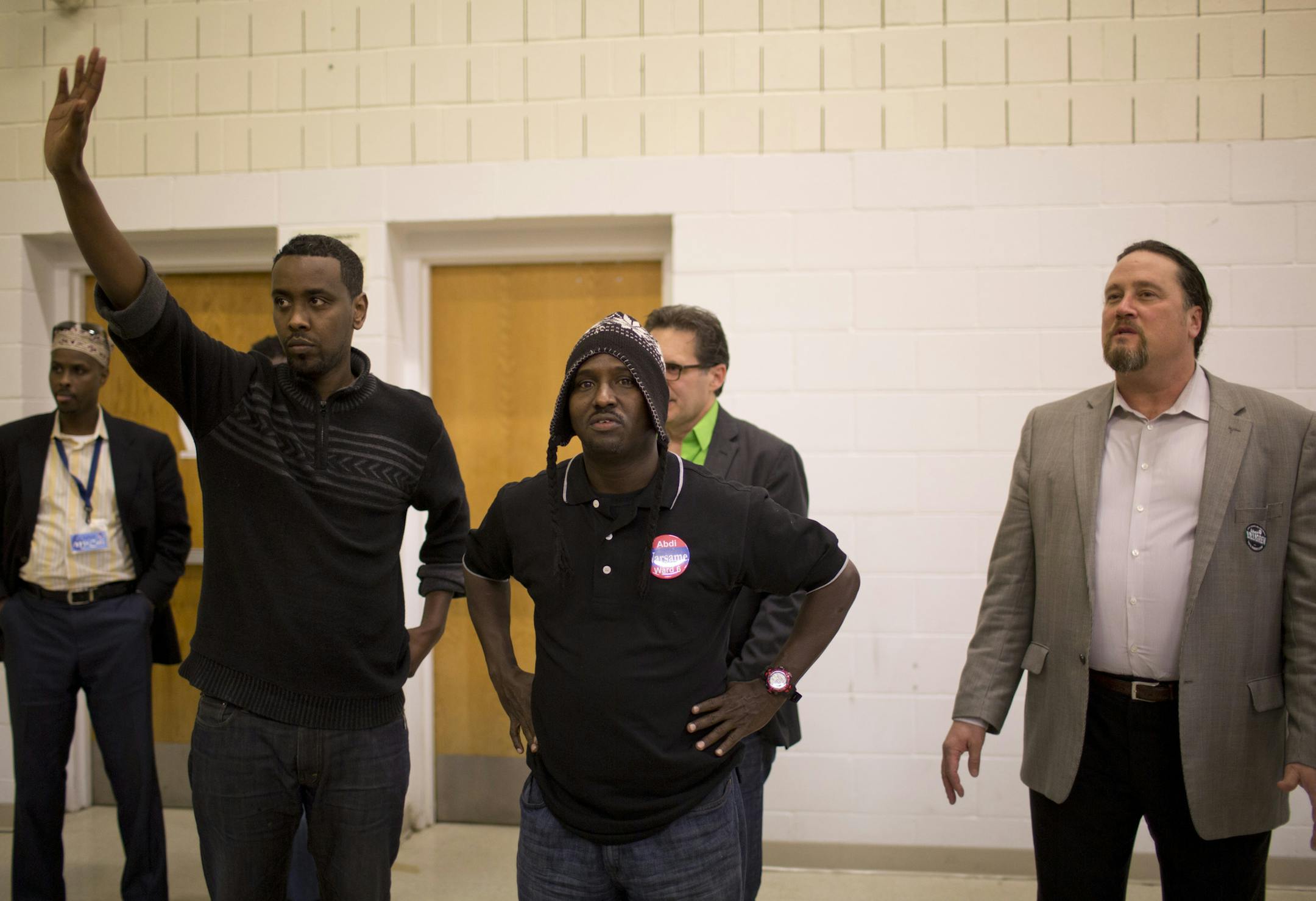 Hundreds of people crowded into the gym at the Bryan Coyle Center to participate in the Ward 6, Precinct 3 caucus Tuesday night, April 16, 2013 in Minneapolis, Minn. Challenger Abdi Warsame, left, and incumbent Robert Lilligren, right, both spoke briefly to the caucus. Between them is Precinct 3 chairman, Habiib Farah. ] JEFF WHEELER ‚Ä¢ jeff.wheeler@startribune.com
