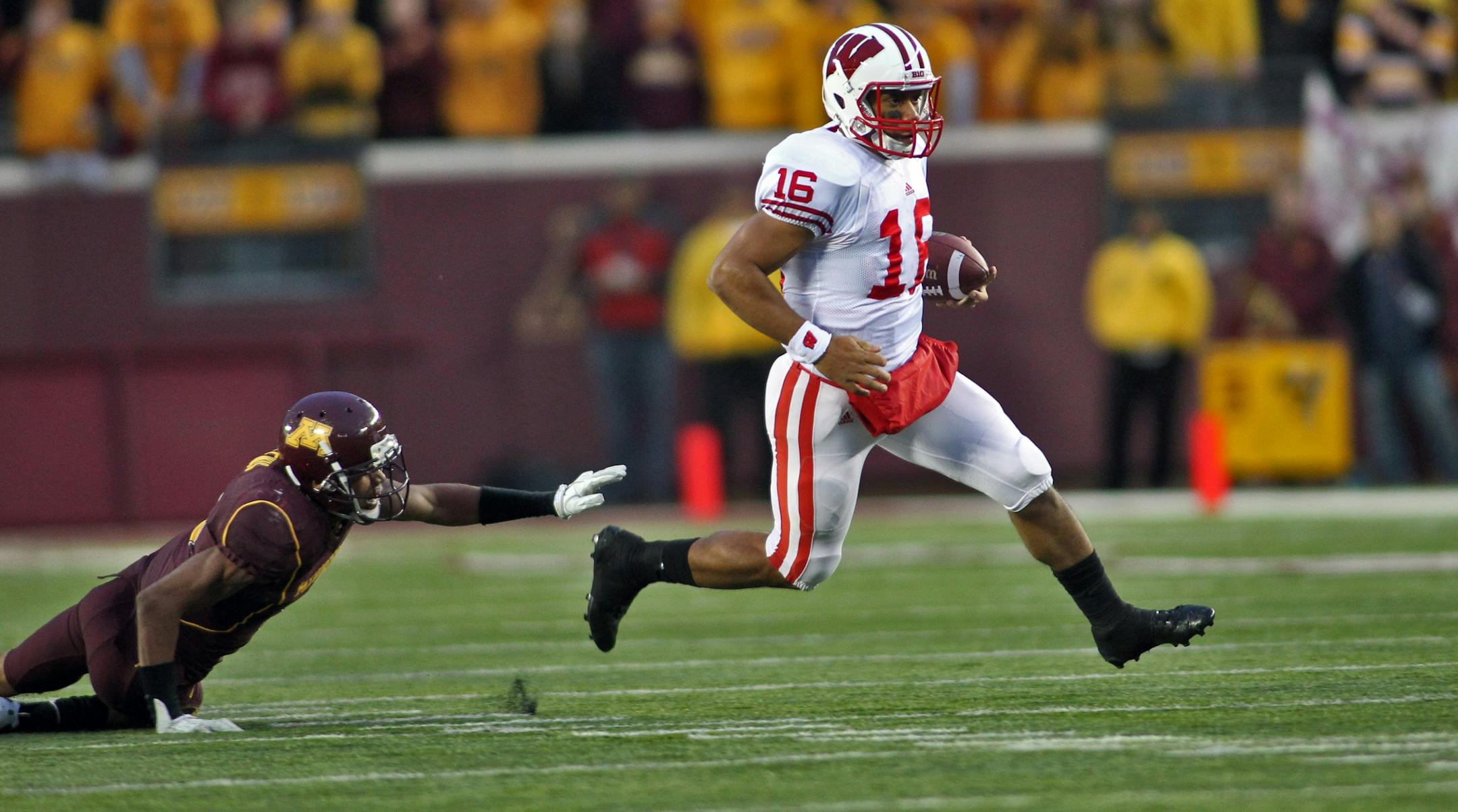UM Gophers football vs. Wisconsin Badgers. Wisconsin won 42-13. Wisconsin quarterback Russell Wilson outran Minnesota defenders.