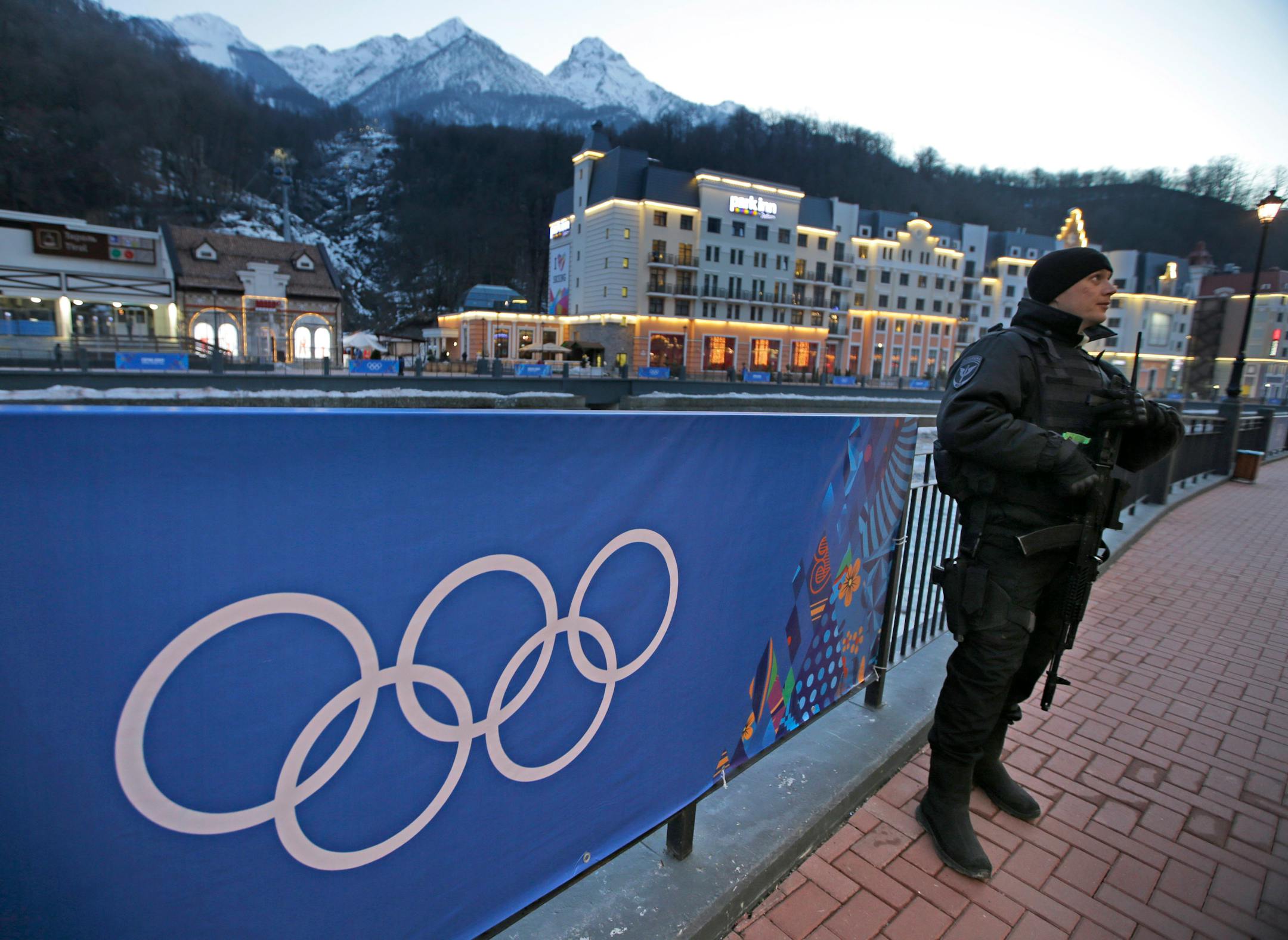 An armed Russian security guard stands at the ski resort Rosa Khutor, where the snow and sliding sports venues for the 2014 Winter Olympics are located, Tuesday, Feb. 4, 2014, in Krasnaya Polyana, Russia. Amid tight security, the U.S. Homeland Security Department is warning airlines flying to Russia that terrorists may try to smuggle explosives on board hidden in toothpaste tubes.