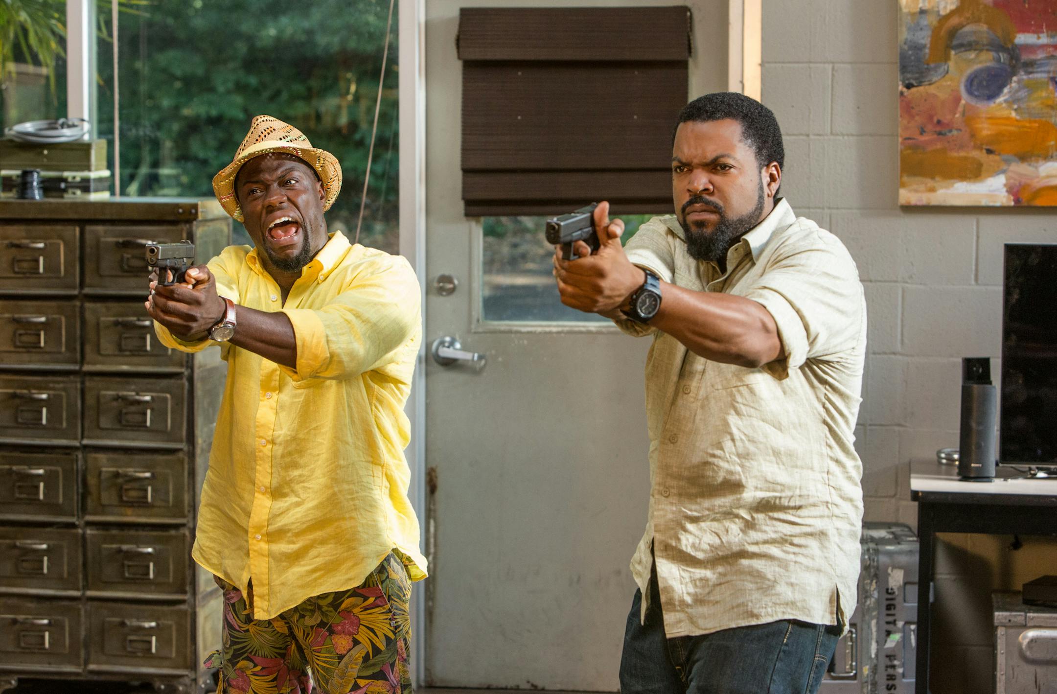 This photo provided by Universal Pictures shows, Kevin Hart, left, as Ben Barber and Ice Cube as James Payton in a scene from the film, "Ride Along 2." The movie opens in U.S. theaters on Jan. 15, 2016. (Quantrell D. Colbert/Universal Pictures via AP)