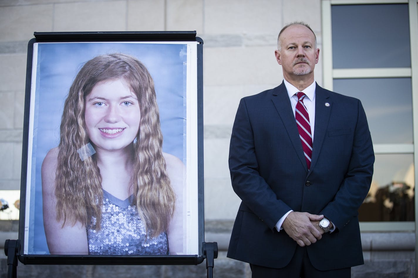 Special agent in charge Chris Deremer with the Wisconsin DCI stands next to a photo of Jayme Closs during the press conference.