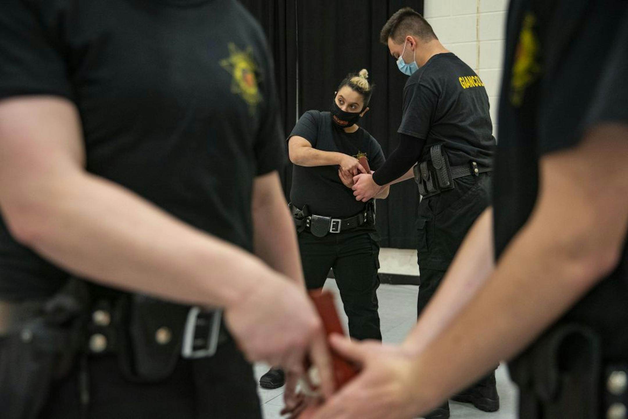 (From left) Law Enforcement trainees Mona Zeidan and Dariano Giancola practiced breaking each other's grips on the barrel of a practice gun during law enforcement training. Defensive tactics class took place in the gymnasium at Fond Du Lac Tribal and Community College in Cloquet, Minn. on Tuesday November 17, 2020.