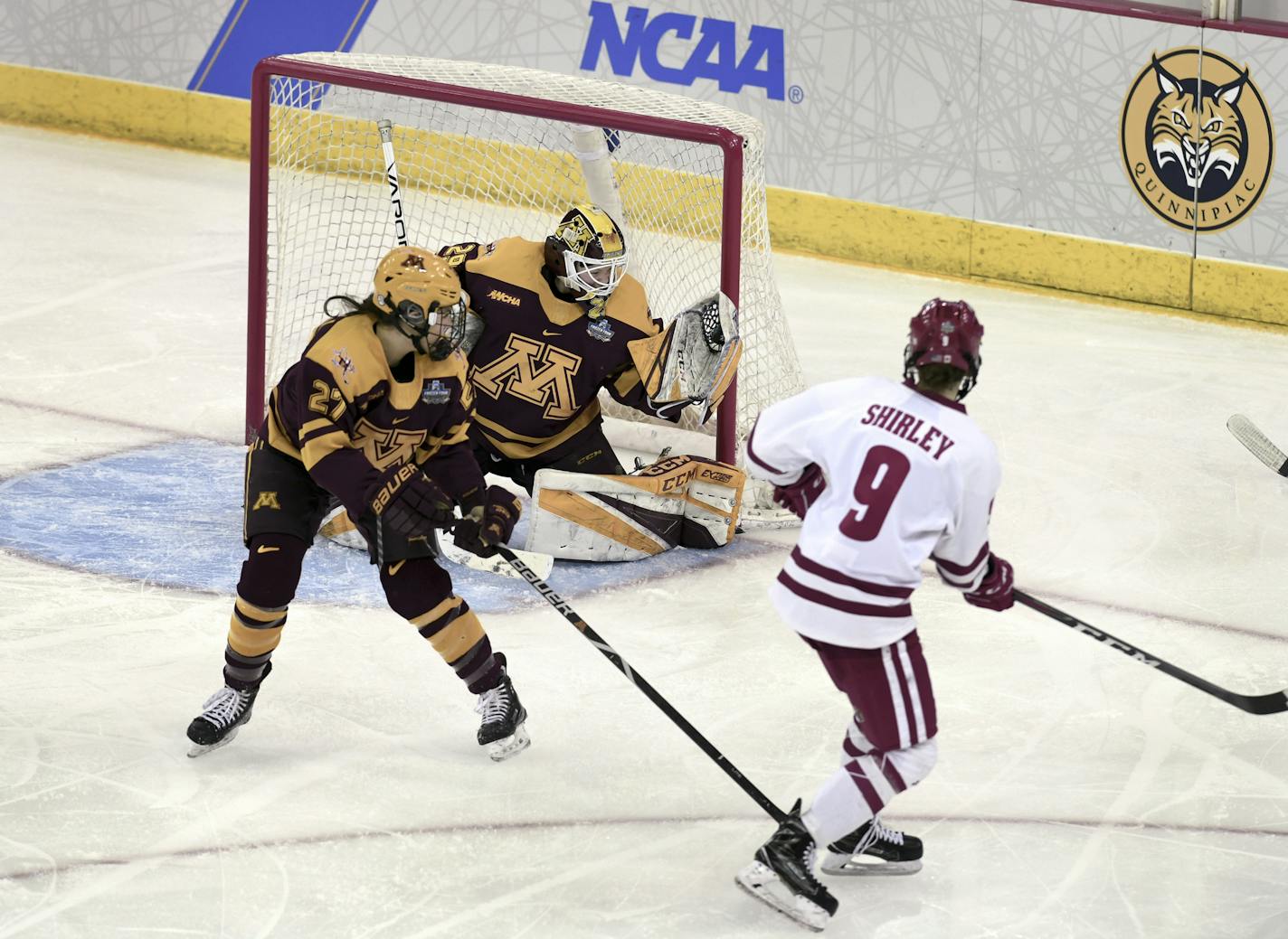 Gophers goaltender Alex Gulstene catches the puck in her glove on a shot by Wisconsin's Sophie Shirley during the 2019 Frozen Four.