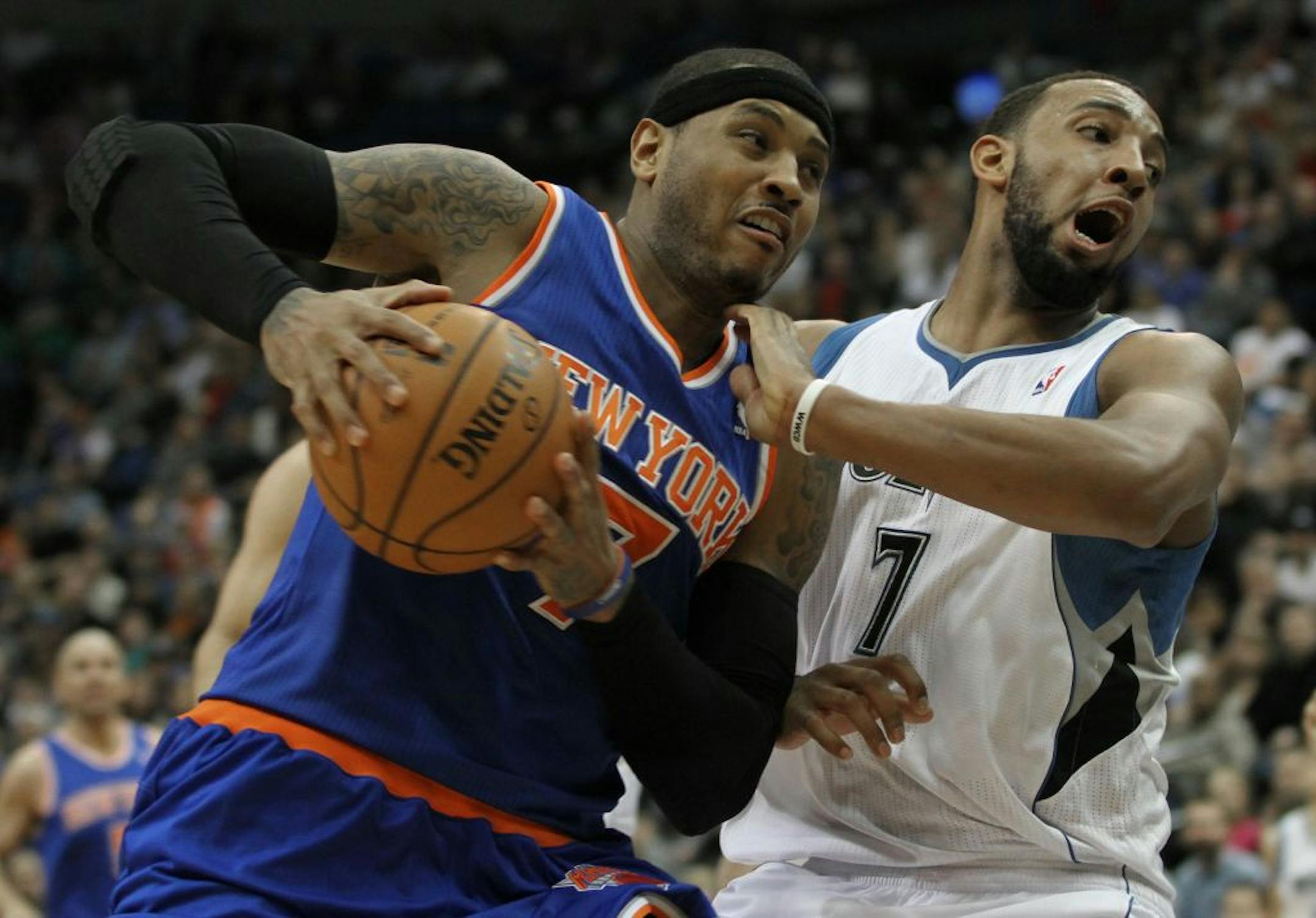 Carmelo Anthony drove on the Wolves' Derrick Williams at Target Center.