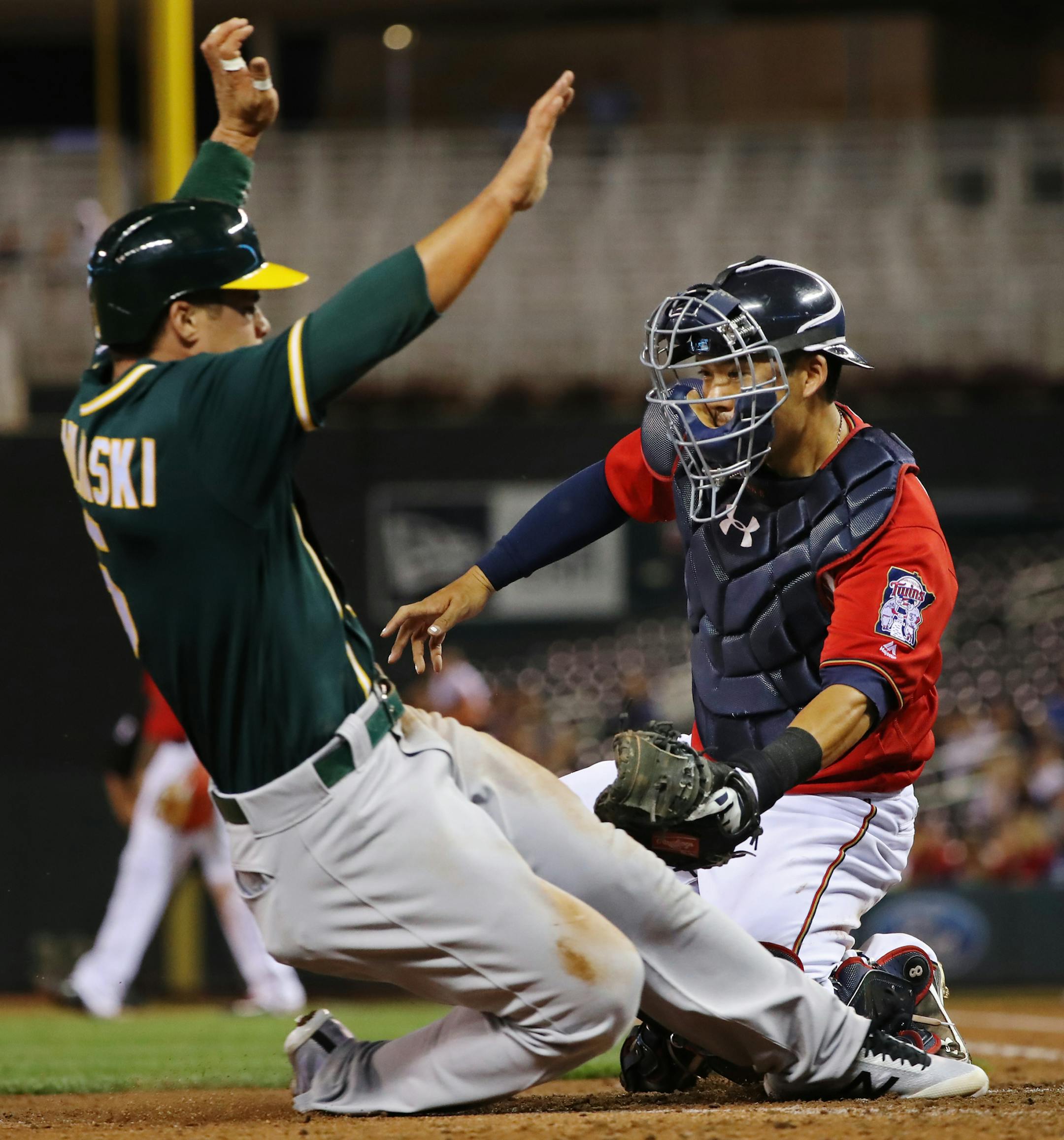 Twins catcher Kurt Suzuki tagged out Oakland&#x2019;s Jake Smolinski at the plate to end the top of the fifth inning, off a perfect throw from left fielder Danny Santana.