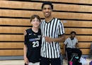 Bloomington Jefferson two-sport star Daniel Freitag posed for a picture with Team Tyus seventh grader Ben Koch. Freitag worked as an official at an AA