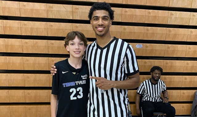 Bloomington Jefferson two-sport star Daniel Freitag posed for a picture with Team Tyus seventh grader Ben Koch. Freitag worked as an official at an AA