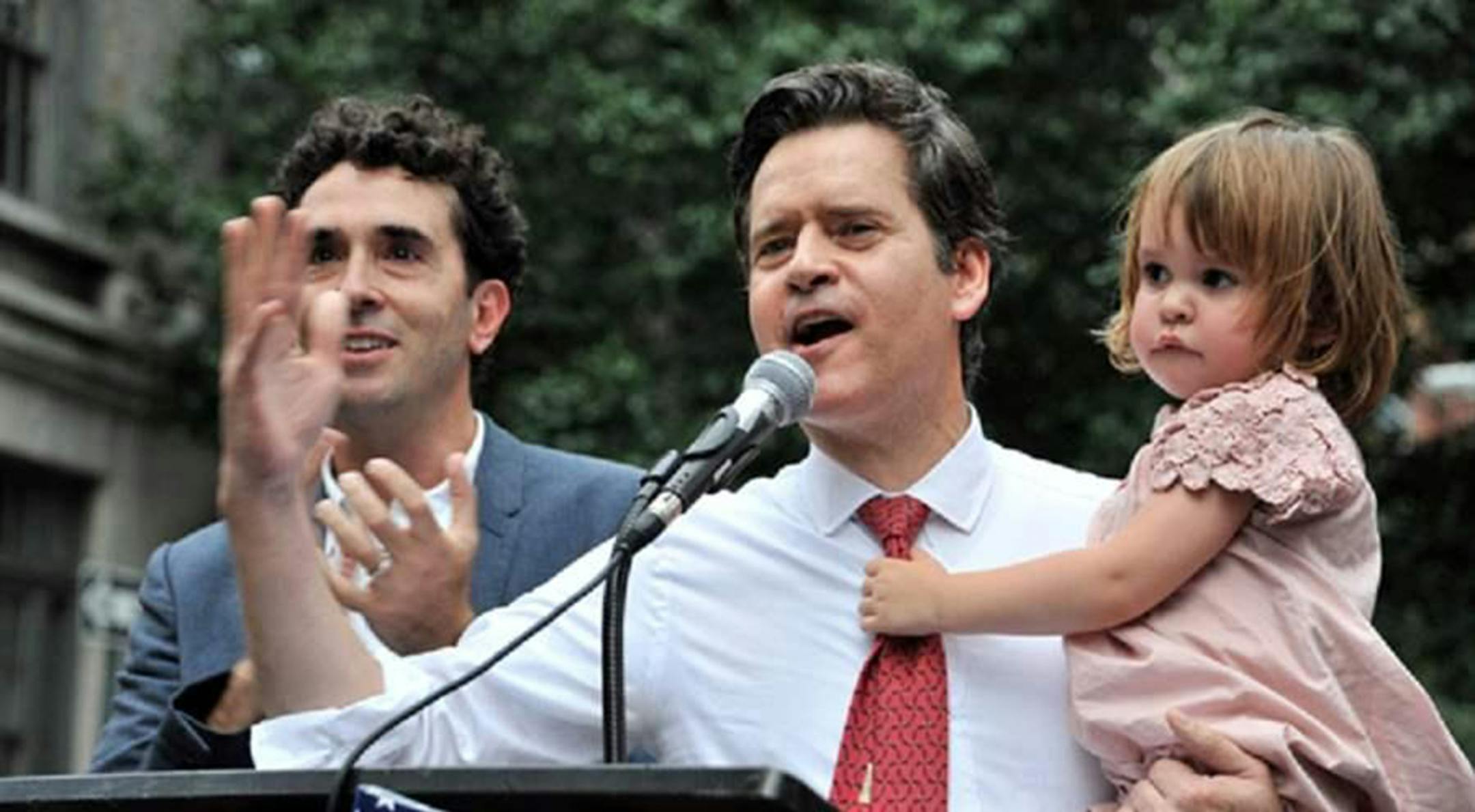 New York state Sen. Brad Hoylman, a Democrat, gives a speech at the Stonewall Inn accompanied by husband David Sigal, and their daughter Silvia, who was carried and delivered by a surrogate. In most states, the law is murky or even silent on surrogacy, but Hoylman hopes to change that in New York. (Brad Hoylman/Pew Charitable Trusts /TNS)