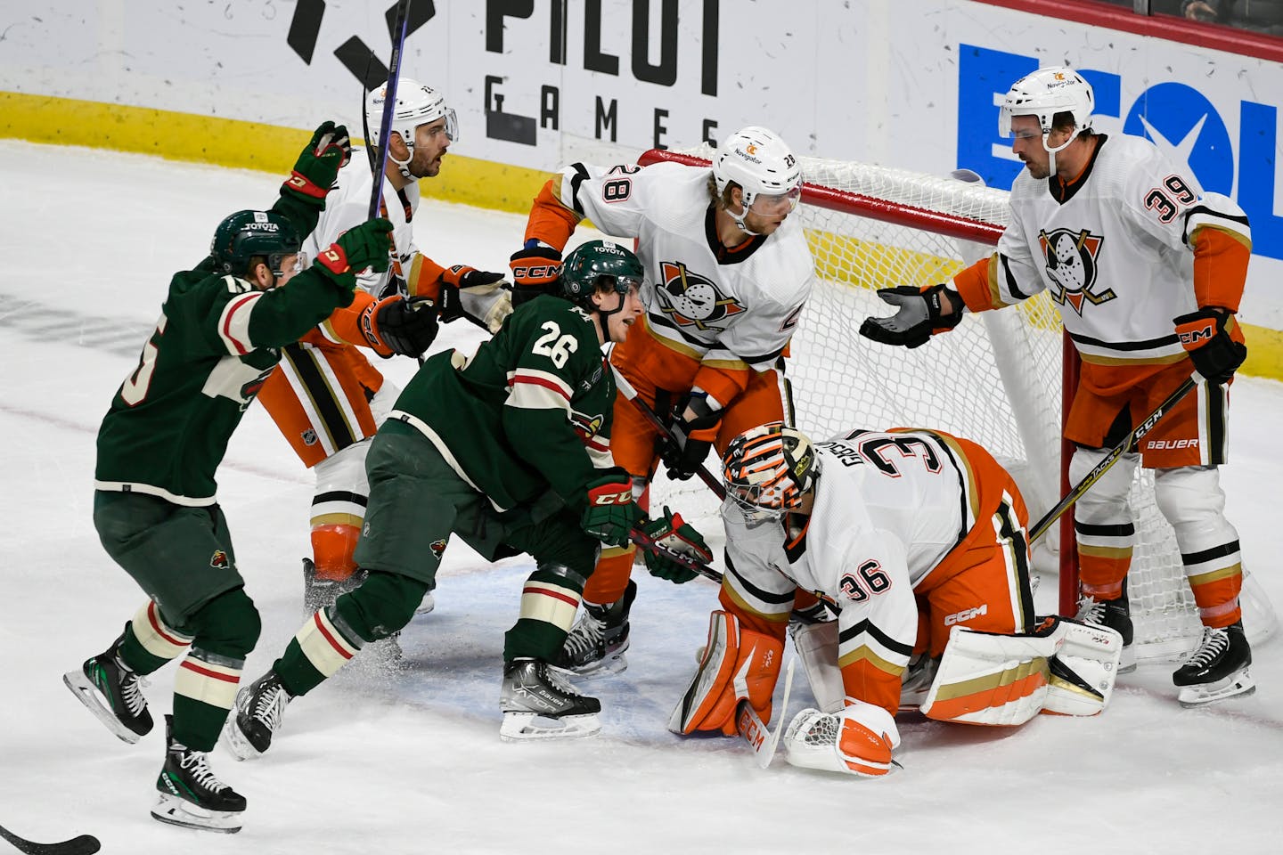 Wild center Connor Dewar (26) pushed the puck past Anaheim goalie John Gibson to score as Wild center Mason Shaw, left, celebrated during the first period Saturday in St. Paul.