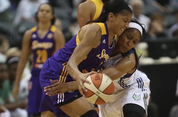 Maya Moore tried to steal the ball away from L.A. star Candace Parker in 2013.