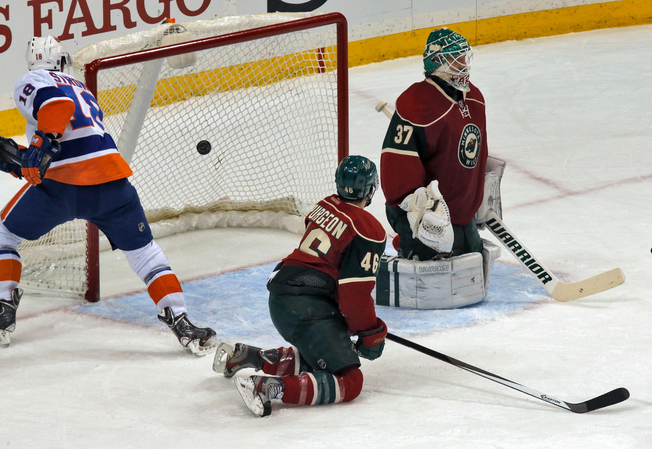 Jared Spurgeon and goalie Josh Harding watched a Cal Clutterbuck shot go by them for a 2nd period goal.