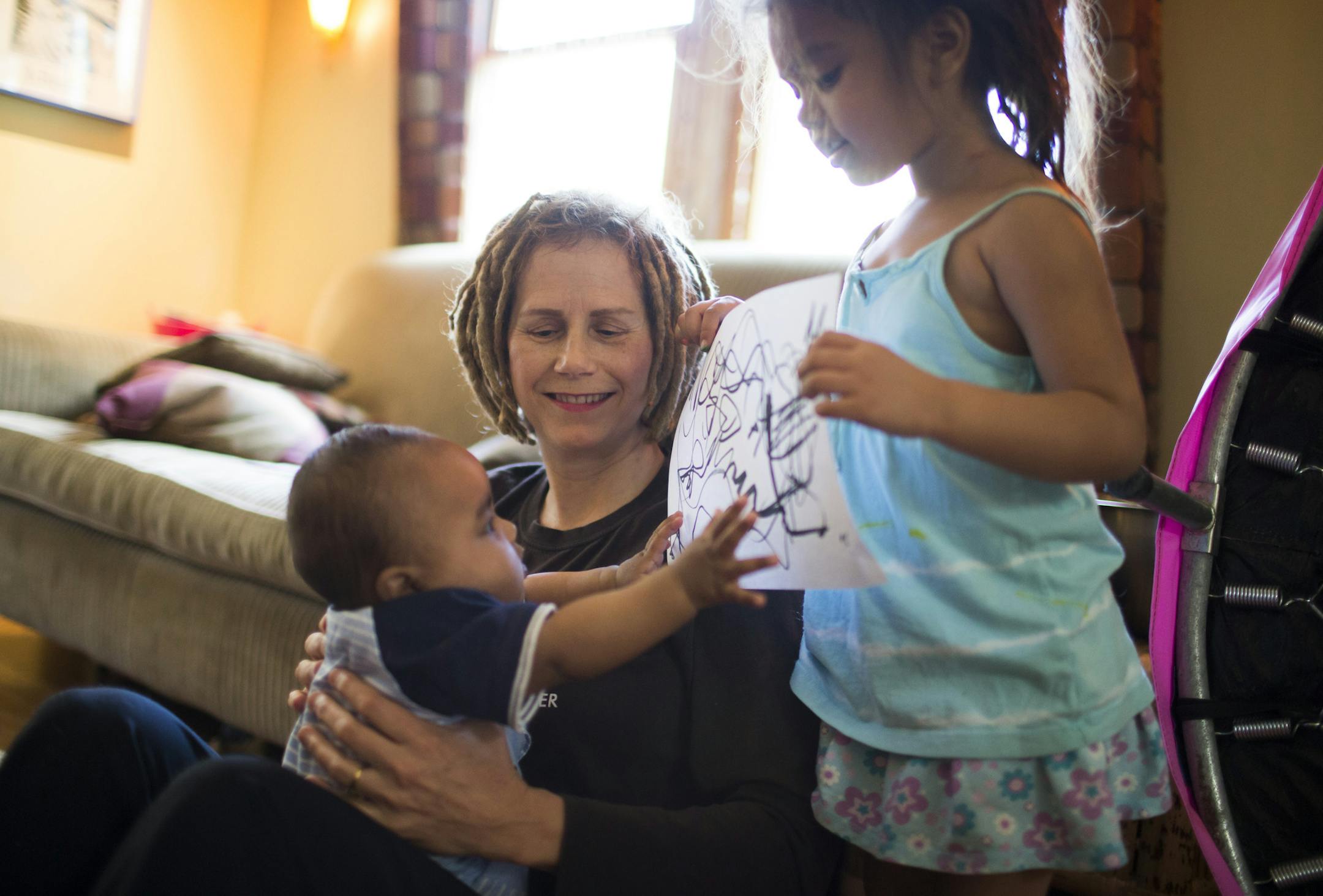 Hannah Lieder sat with her foster son Louis as her foster daughter Alena showed off some of her artwork on Monday, May 4, 2015, in Minneapolis, Minn. ] RENEE JONES SCHNEIDER • reneejones@startribune.com