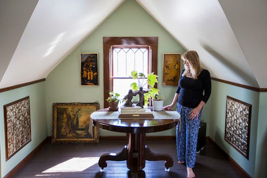 Carol Murto and Robert Nicpon turned the open rafter attic in their 1913 home in St. Paul into a comfortable TV room, artist studio and gallery.