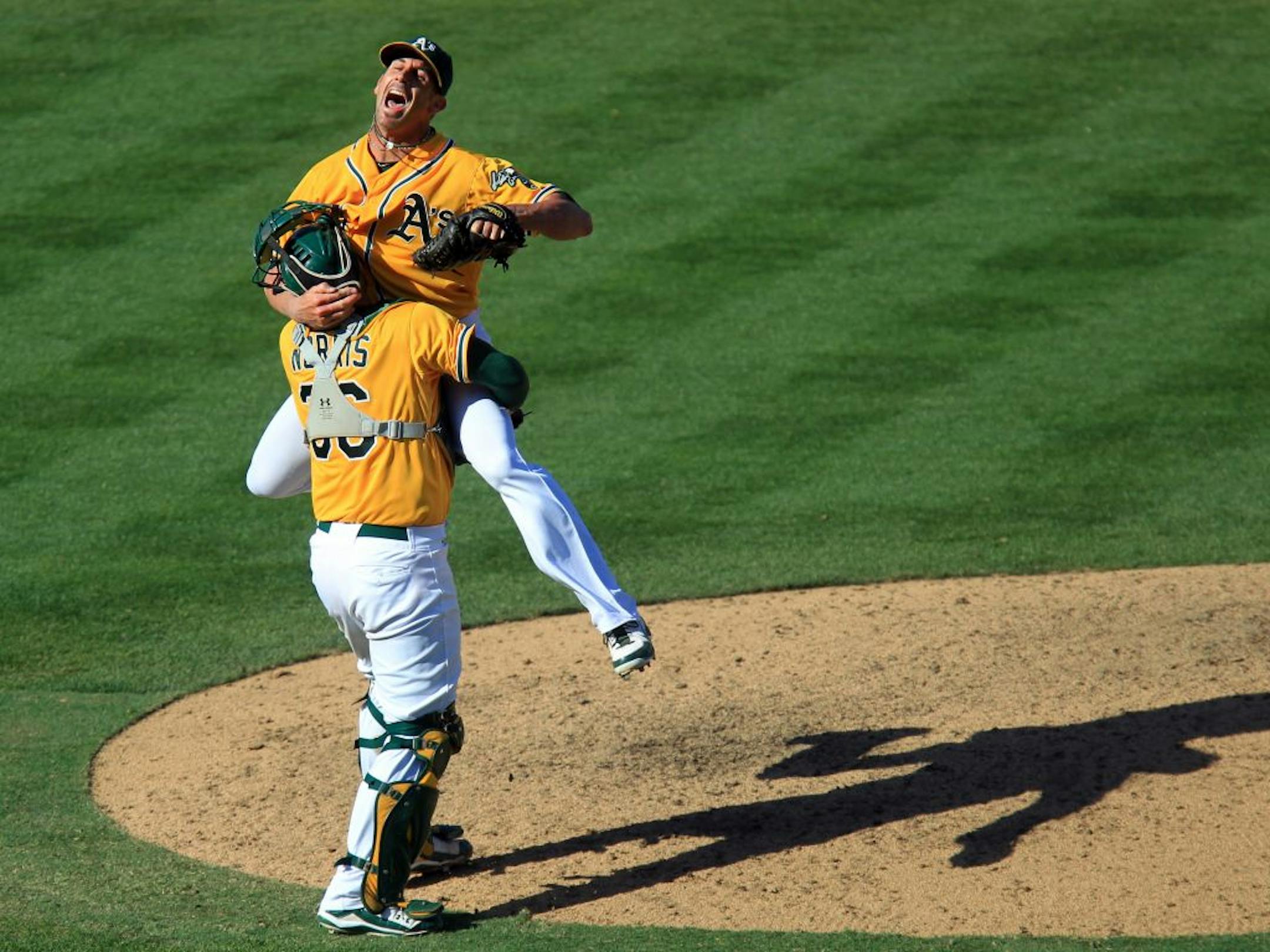 Oakland Athletics catcher Derek Norris (36) and closing pitcher Grant Balfour (50) exult in celebration after the last out against Texas Rangers' Michael Young at O.co Coliseum in Oakland, California, on Wednesday, October 3, 2012. The A's claimed the American League West Division title after beating the Rangers 12-5 in a tie-breaker game.
