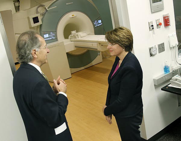 Dr. Kamil Ugurbil, left, gave Senator Amy Klobuchar, center, a tour of the Center for Magnetic Resonance Research Center at the U of M, Tuesday, April