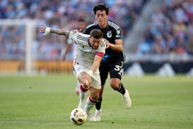 FC Dallas forward Paul Arriola, front, and Minnesota United midfielder Caden Clark battle for possession during the first half of Saturday's game in S