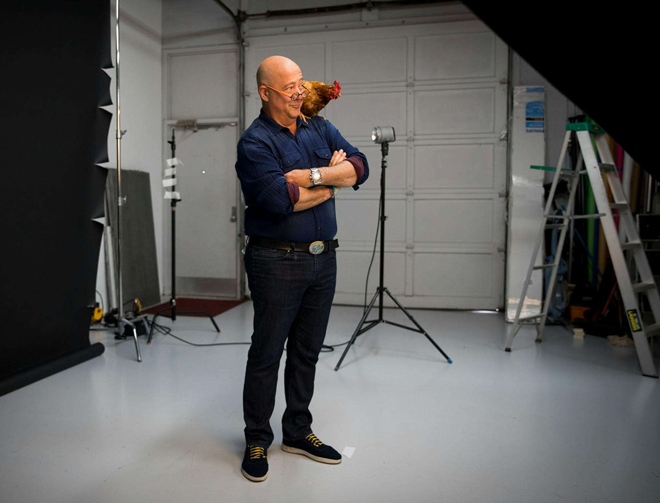 Andrew Zimmern's posed with a hen during a photoshoot for a Midwest Living story at photographer Steve Henke's studio in Golden Valley, Minn., on Friday, May 26, 2017.