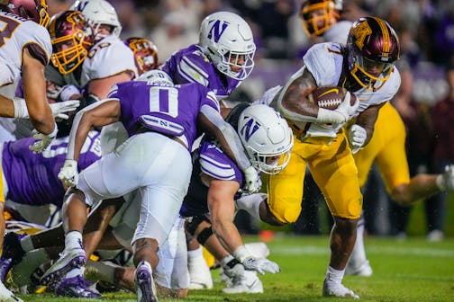 Gophers running back Darius Taylor fought his way into the end zone for a touchdown against Northwestern during the first half Saturday in Evanston