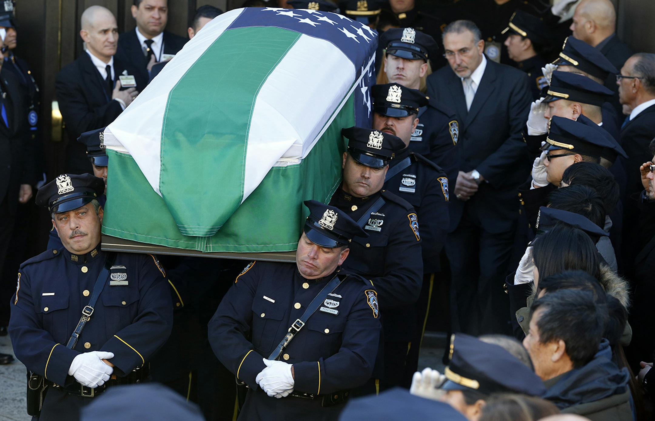 Pallbearers carry the casket of New York City police officer Rafael Ramos following funeral services at Christ Tabernacle Church, in the Glendale section of Queens, Saturday, Dec. 27, 2014, in New York. Ramos and his partner, officer Wenjian Liu, were killed Dec. 20 as they sat in their patrol car on a Brooklyn street. The shooter, Ismaaiyl Brinsley, later killed himself. (AP Photo/Julio Cortez) ORG XMIT: MIN2014122713215164