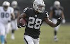 FILE - In this Nov. 26, 2016, file photo, Oakland Raiders running back Latavius Murray (28) carries the ball against the Carolina Panthers during an N
