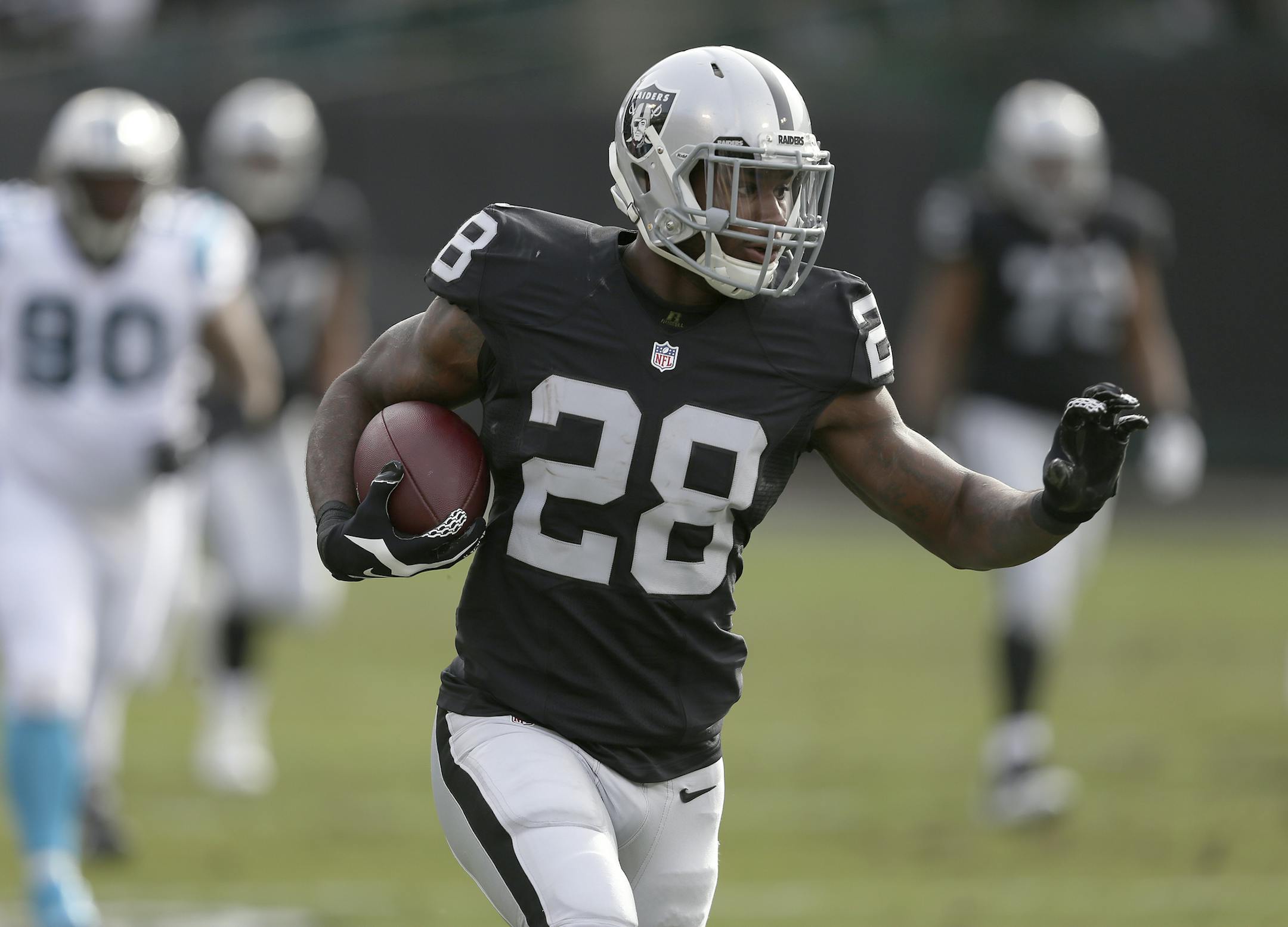 FILE - In this Nov. 26, 2016, file photo, Oakland Raiders running back Latavius Murray (28) carries the ball against the Carolina Panthers during an NFL football game in Oakland, Calif. The Minnesota Vikings have signed former Oakland Raiders running back Latavius Murray. The team announced the signing early Thursday morning, March 16, 2017. (Daniel Gluskoter/File)