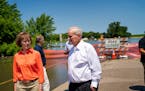 Gov. Mark Dayton and Sen. Tina Smith looked out Friday at County Road 38, cut off by the flooded Des Moines River in Currie, Minn.