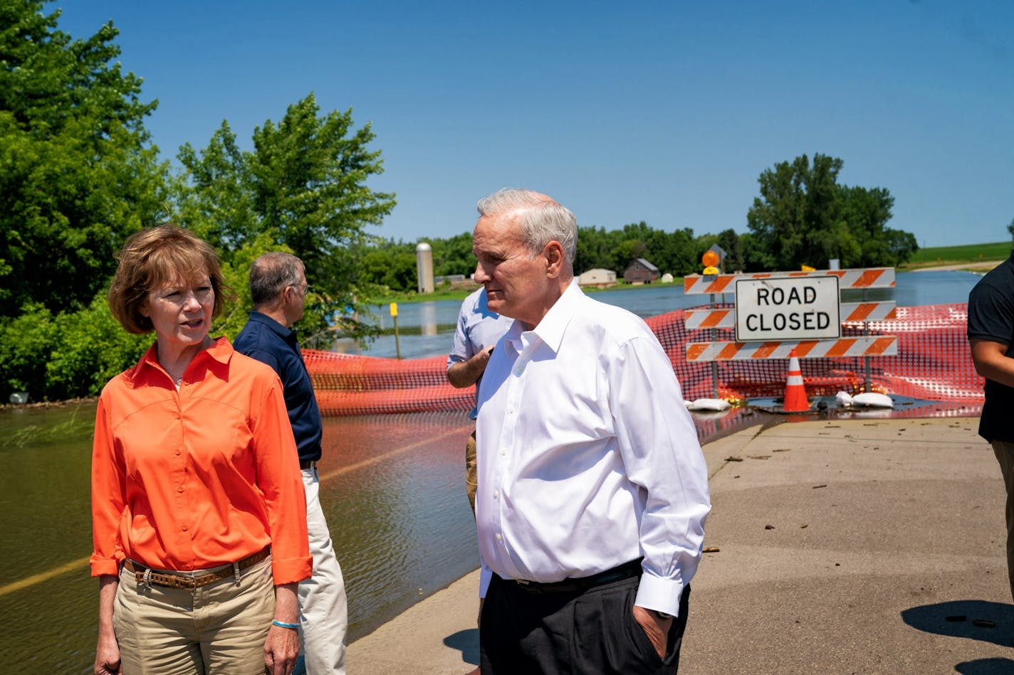 Gov. Mark Dayton and Sen. Tina Smith looked out Friday at County Road 38, cut off by the flooded Des Moines River in Currie, Minn.