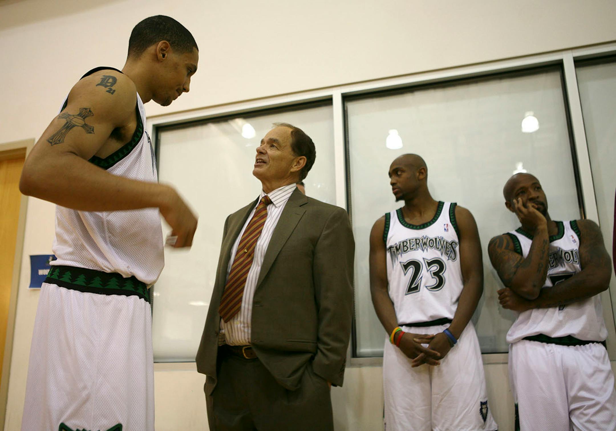 Timberwolves owner Glen Taylor visited with rookie center Dwayne Jones while he and Trent Hassell (23) and Anthony Carter (7) waited to have their team publicity photos taken.
GENERAL INFORMATION: Jeff Wheeler/Star Tribune
MINNEAPOLIS - 10/3/05 - The Minnesota Timberwolves got their season off to start with Media Day Monday afternoon at the Wolves' practice facility at Target Center.