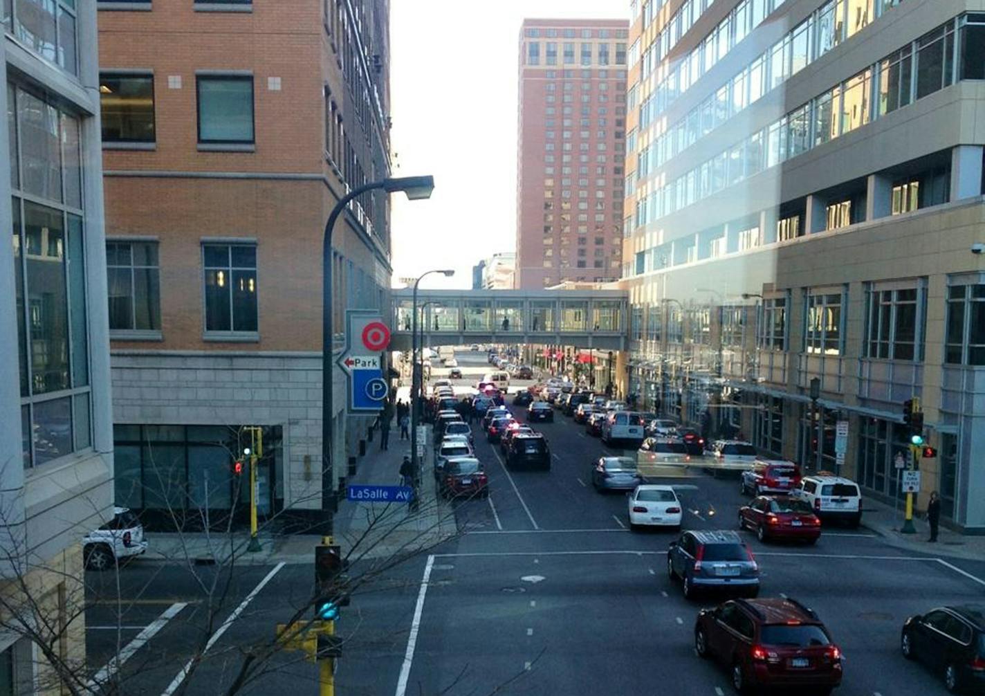 Police are investigating a report of possible shots fired in the Retek Building in downtown Minneapolis. The building at 10th Street and Nicollet is part of the Target downtown campus. This photo shows cars stopped at 10th and LaSalle. Photo: Bill Zych