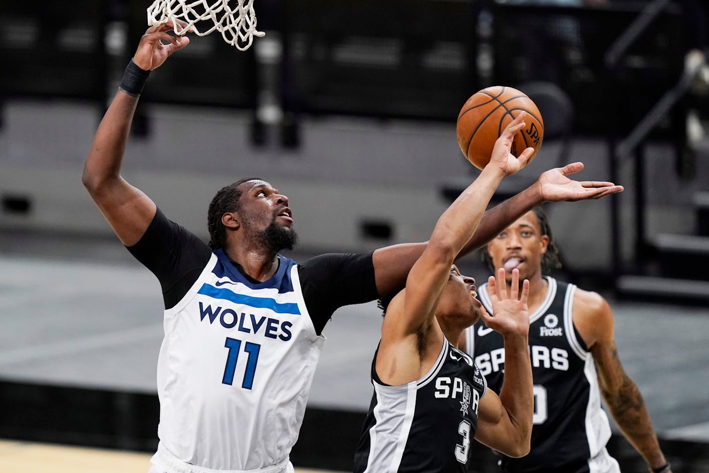 Timberwolves center Naz Reid shoots over San Antonio forward Keldon Johnson during the second half