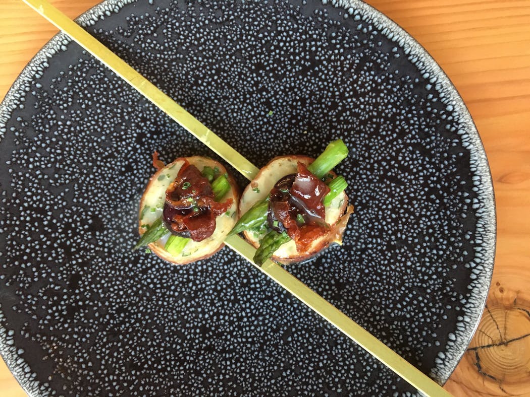 Pork-wrapped Shrimp Farse with Black Currant and Asparagus.