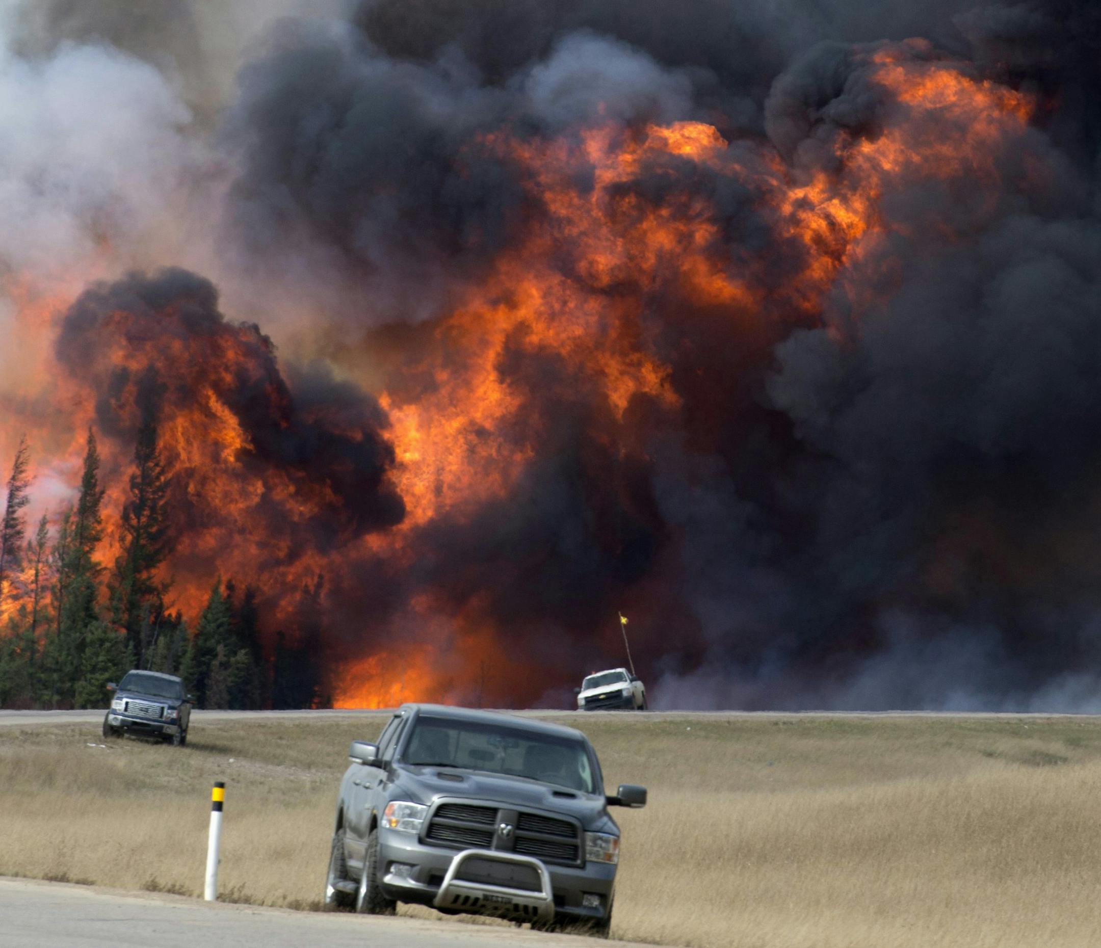 FILE - In this May 7, 2016 file photo, a wildfire burns south of Fort McMurray, Alberta. A dry and blistering hot northern Alberta is burning and doing so unusually early in the year, but thatís only the latest of many gargantuan fires on an Earth thatís grown hotter with more extreme weather. (Jonathan Hayward /The Canadian Press via AP, File) MANDATORY CREDIT