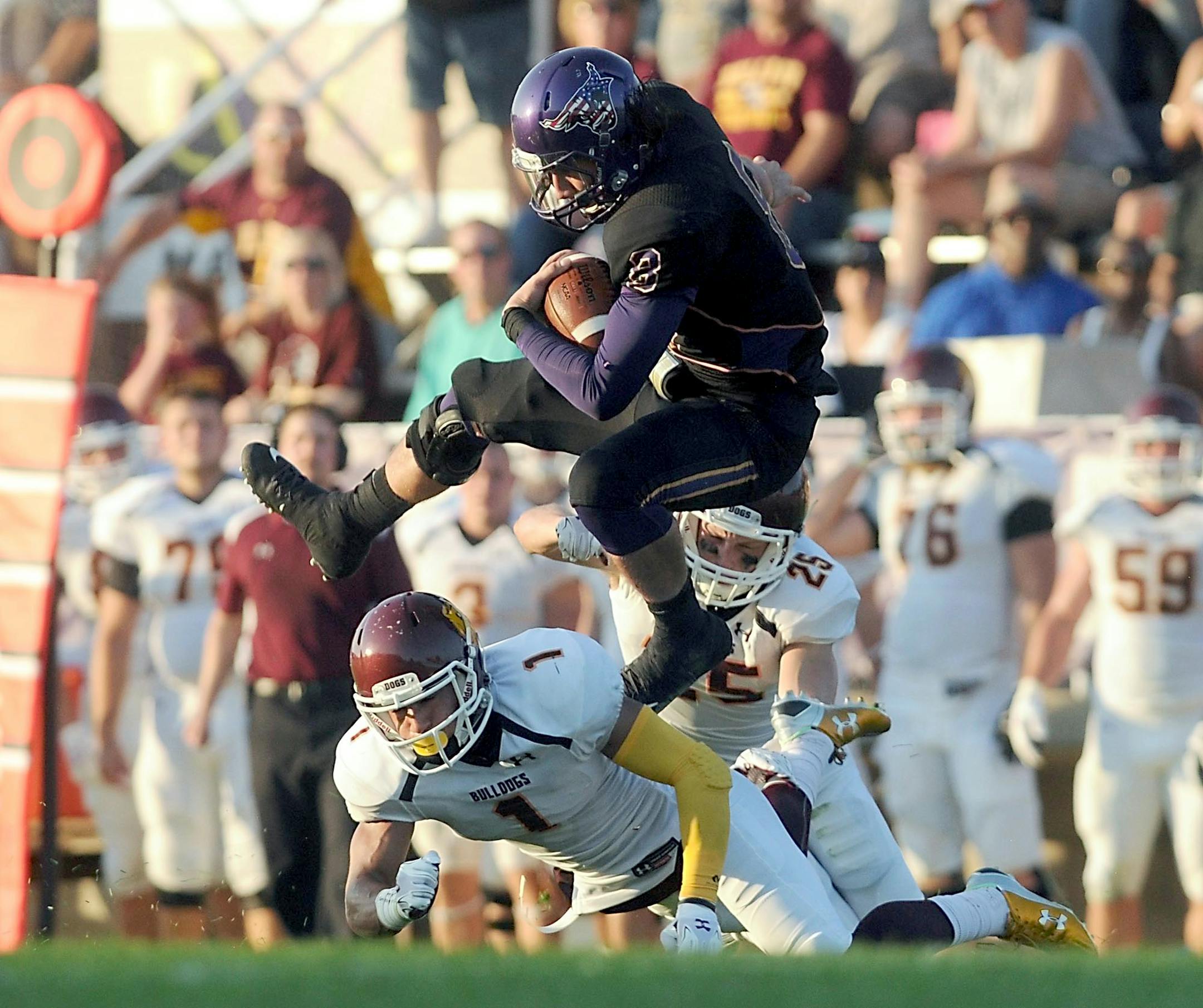 Minnesota State quarterback Ricky Lloyd (8) hurdles University of Minnesota-Duluth defender Darion Fletcher (1) during the first half Thursday at Blakeslee Stadium. Photo by Pat Christman/Mankato Free Press