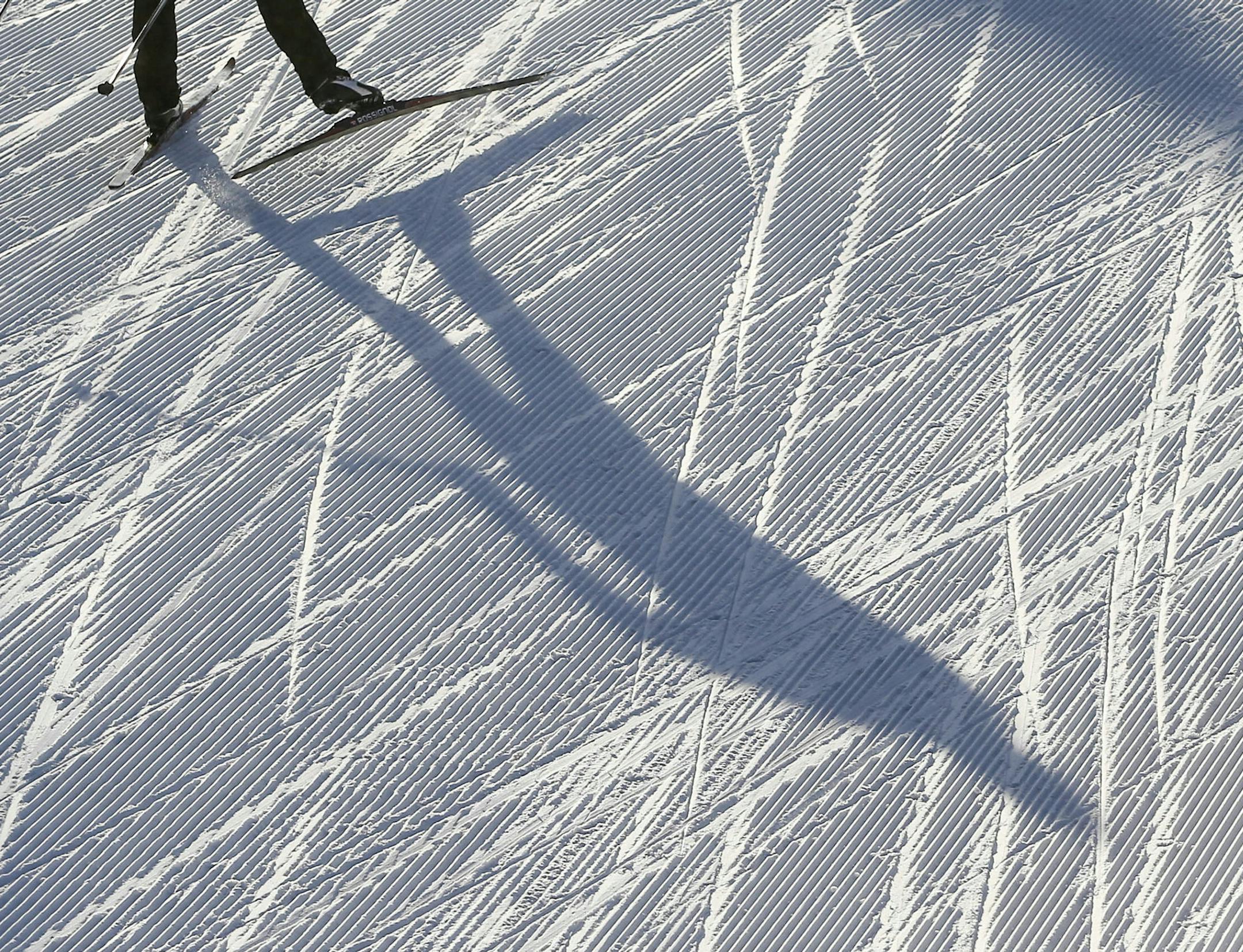 A cross country skier using the skating technique casts a shadow on a groomed trail Tuesday, Nov. 25, 2014, at Elm Creek Park Reserve in Maple Grove.](DAVID JOLES/STARTRIBUNE)djoles@startribune Snow and lots of it is on the ground at Elm Creek Park Reserve, a Three Rivers Park District property, for cross country skiers hoping to get an early start on winter. ORG XMIT: MIN1411251646561393